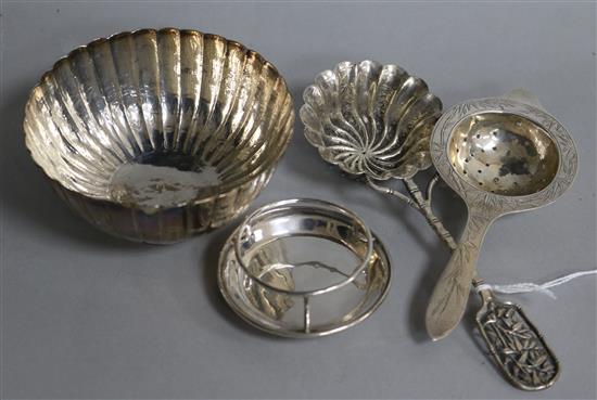 A Chinese silver sugar bowl and two tea strainers.